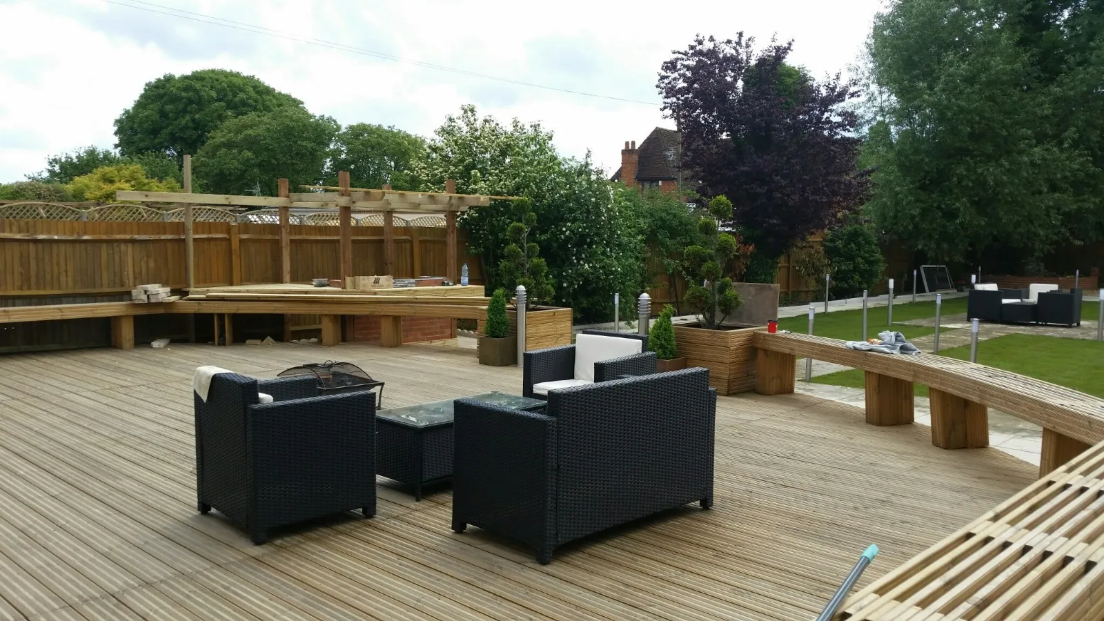 decking,seating and bbq area with landscaped gardens